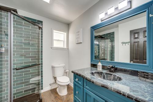 a bathroom with a sink and a toilet and a mirror at Artsy Cottonwood Stay with Hot Tub, Walk to Wineries in Cottonwood