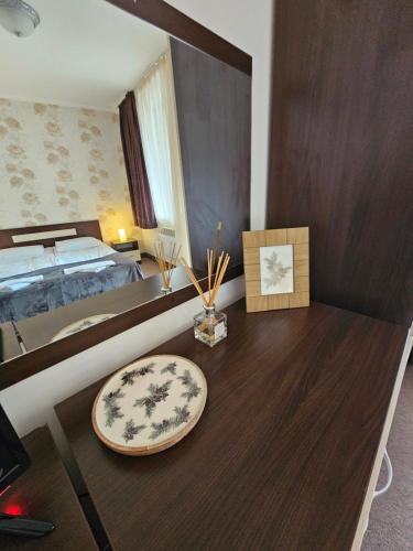 a bedroom with a bed and a wooden desk at Viva 5 apartment Grand Monastery on the ski slopes in Pamporovo