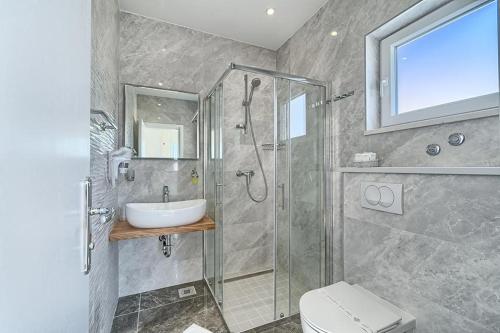 a bathroom with a shower and a sink and a toilet at Hotel Trogirski Dvori in Trogir