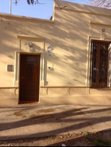 um edifício branco com uma porta e uma janela em Rivadavia em Pérez
