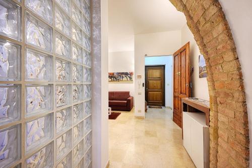 a hallway with a wall of glass tiles at Elehome2 nel cuore della città in Siena