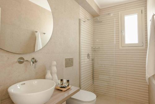 a bathroom with a toilet and a sink and a shower at Ostria Villa in Divarata