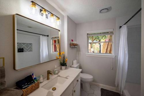 a bathroom with a sink and a mirror at Heated Pool Retreat OutdoorTV BBQ and Cozy Gazebos in Houston