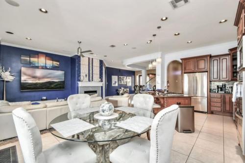 a kitchen and living room with a glass table and chairs at Waterfront Dream InfinityHeatdPool and SPA BY NASA in Seabrook