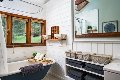 a bathroom with a tub and a sink at Evergreen Castle - SLEEPS 8 - Close to skiing in Evergreen