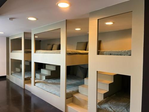 a room with three bunk beds with mirrors at La Petite Fleur in Baarle-Nassau