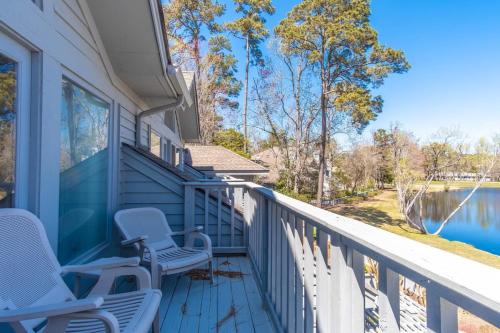 a porch with chairs and a view of the water at Tidewater- Teal lake #2521 in North Myrtle Beach
