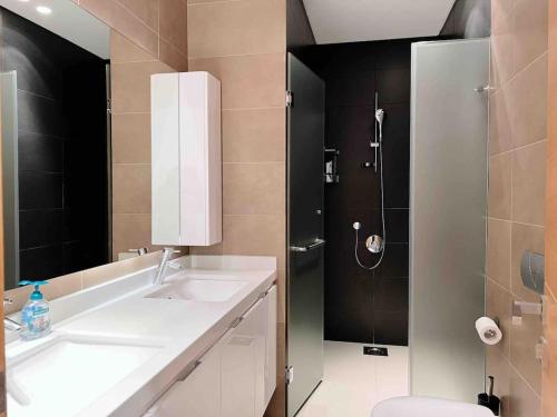 a bathroom with a sink and a shower at Gorgeous 3Br Achrafieh Apt in Beirut
