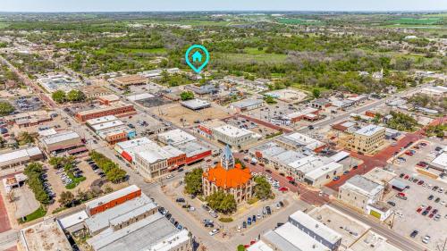 an aerial view of a city with a green balloon in the air at Captain James Beech House in Stephenville