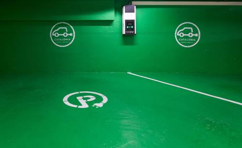 a green tennis court with three stickers on it at Catalonia Passeig de Gràcia 4* Sup in Barcelona