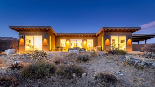 a house in the middle of a field with at Shelter 2 l A Classic At Joshua Tree Park Entrance in Joshua Tree