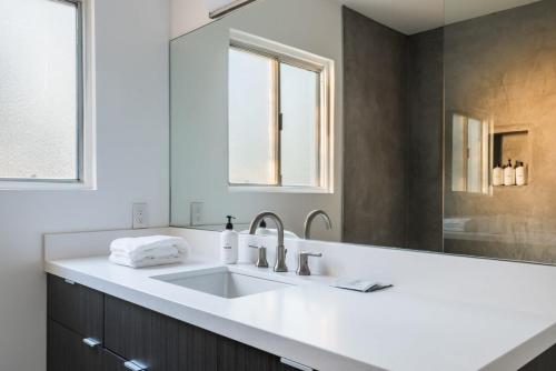 a bathroom with a sink and a mirror at Hidden Valley Cottage - Modern Home in JT Hot Tub in Joshua Tree