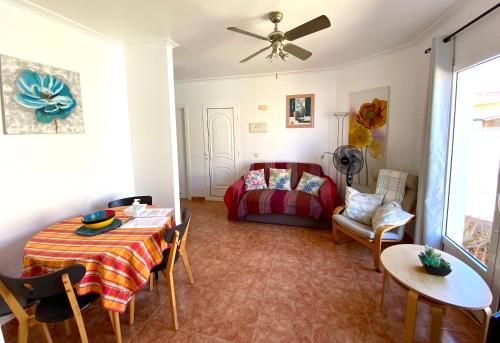 sala de estar con mesa y cama en Villa Azure, en Caleta de Fuste