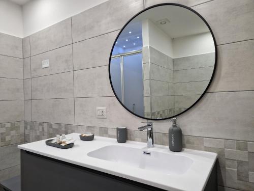 a bathroom with a sink and a mirror at Stylish Apartment Norcia in Norcia
