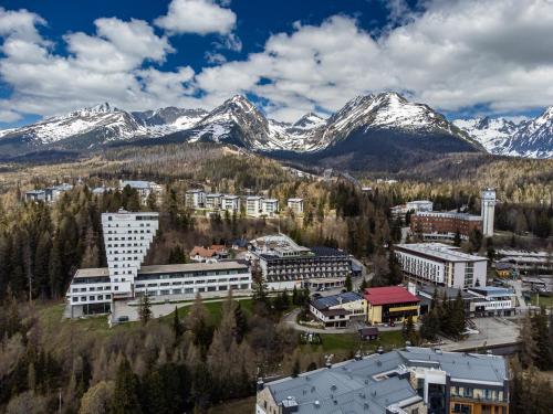 an aerial view of a city with snow covered mountains at Hotel Toliar in Štrbské Pleso