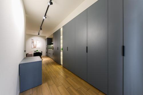 a room with white cabinets and a hallway at Luxury Apartments-Belochka in Uzhhorod