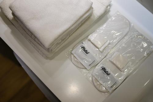 two towels and a bag of soap on a table at Luxury Apartments-Belochka in Uzhhorod