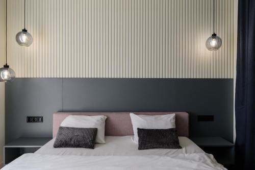 a bedroom with a bed with two pillows at Luxury Apartments-Belochka in Uzhhorod