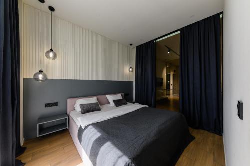 a bedroom with a large bed in a room at Luxury Apartments-Belochka in Uzhhorod