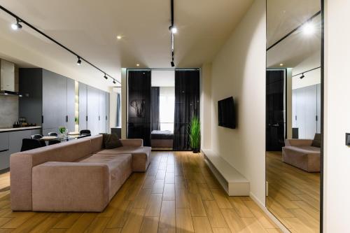 a living room with a couch and a table at Luxury Apartments-Belochka in Uzhhorod