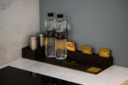two bottles sitting on a shelf in a kitchen at Luxury Apartments-Belochka in Uzhhorod