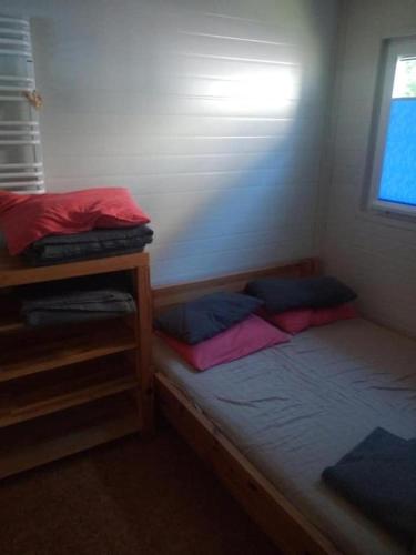a bed in a room with two bunk beds at Domek 1 in Dębki