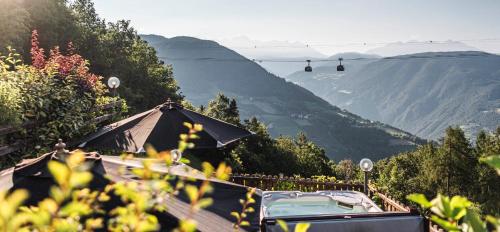 a car parked on the side of a mountain at Chalet Grumer Suites&Spa in Soprabolzano
