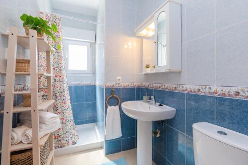 y baño de azulejos azules con lavabo y ducha. en Dreamscape Retreat by Fidalsa, en La Manga del Mar Menor