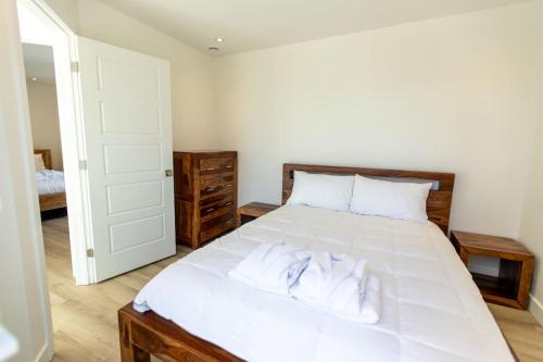 a bedroom with a white bed with two towels on it at Chalet Luméo in Brownsburg