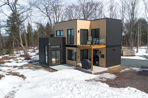 a house is shown in the snow at Chalet Luméo in Brownsburg