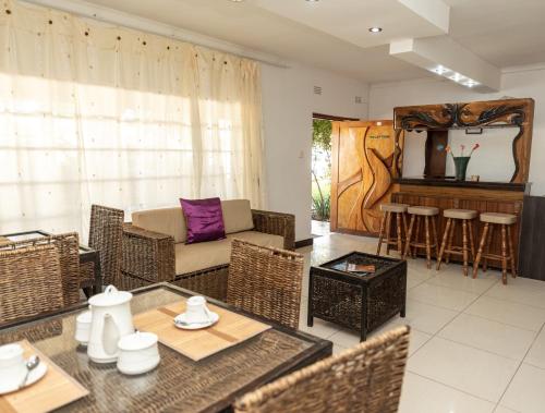 un soggiorno con divano e tavolo di Mumses Guest House a Ramotswa