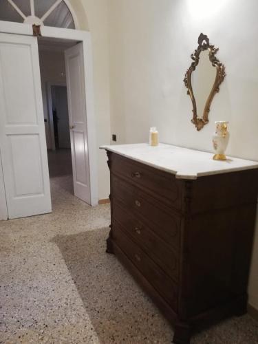 a dresser with a mirror on top of it at Palazzo Conforti in Calvanico