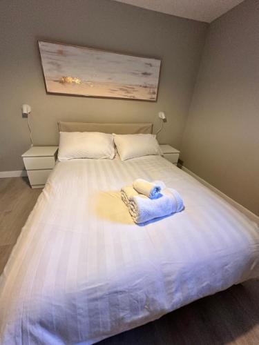 a bed with two towels on top of it at Great Northern Apartment in Aberdeen