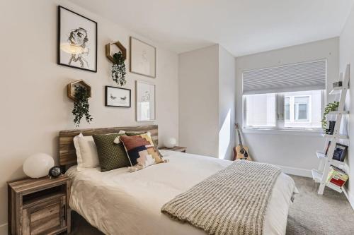 a bedroom with a large bed and a window at 4BR Upscale Townhome Roof Top w Skyline Views in Denver