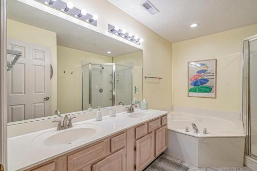 a bathroom with two sinks and a shower and a tub at Tidewater Golf Community 722 Teal Lake in North Myrtle Beach