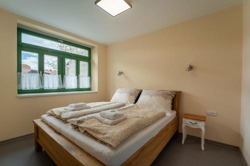 a bedroom with a bed with towels on it at Slovanský penzion in Mikulčice