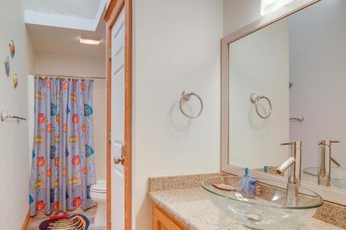 a bathroom with a sink and a mirror at Coastal Home with Deck, Outdoor Shower Walk to Beach in Kill Devil Hills