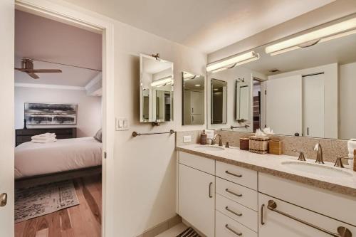 a bathroom with two sinks and two mirrors at Larimer Luxury Top Notch Amenities Walk to All in Denver