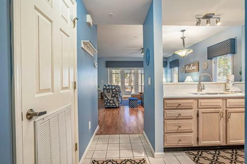 een keuken met blauwe muren en een witte deur bij Teal lake 1311 in North Myrtle Beach