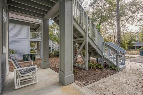 a porch with two chairs and a staircase on a house at Teal lake 1311 in North Myrtle Beach