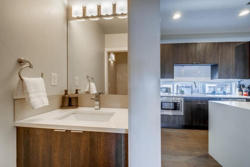 a kitchen with a sink and a microwave at Roof Top Deck w Views Walk to Empower Field in Denver