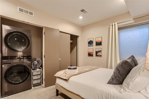 a bedroom with a washing machine next to a bed at Serenity at Sloan's 1-BR with a Modern Twist in Denver