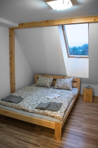 a bed in a room with a window at Apartmány ve Dvoře in Herálec