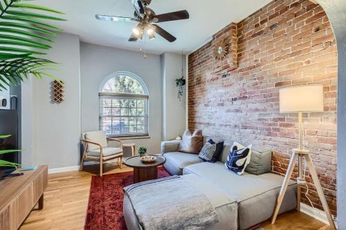 a living room with a brick wall and a couch at RiNo Charmer 2bd Family Home Ev Charger in Denver
