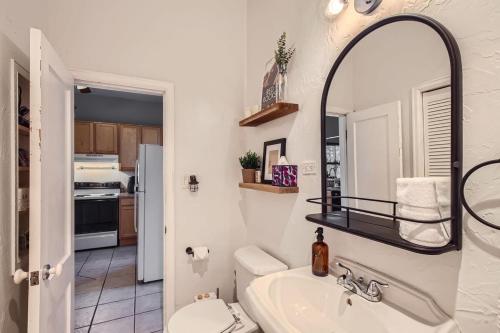 a bathroom with a sink and a mirror at RiNo Charmer 2bd Family Home Ev Charger in Denver