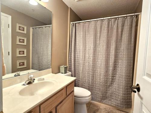 a bathroom with a sink and a toilet and a shower at Teal Lake 1413 in North Myrtle Beach
