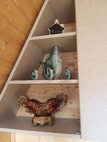 a shelf with a chicken and other items on it at Emotion Kazbegi in Stepantsminda