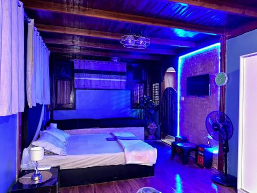 um quarto com uma cama com iluminação azul em استوديو روف جديد وأنيق في المعادي no Cairo