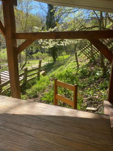 a wooden porch with a view of a fence at Camping Les Escargots Bleus in Prades