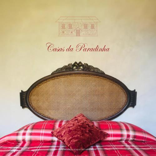 a bed with a pillow on top of it at Casa da Ribeira- Riverside Retreat by Paiva River Beach in Arouca